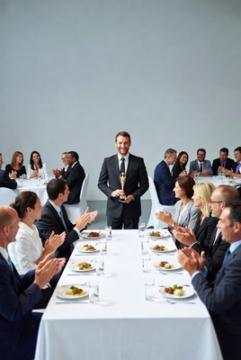 Man holding award at business dinner