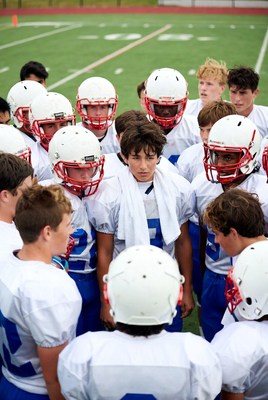 Football team huddle on field