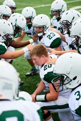 Football team huddle on field