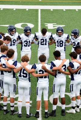 Football team huddle on field