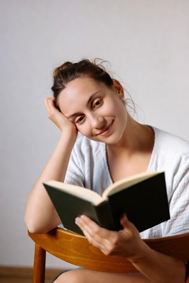 Woman reading book in chair