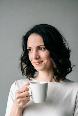 Woman holding white coffee mug