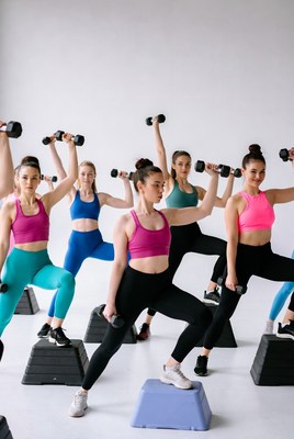 Group of women doing dumbbell squats