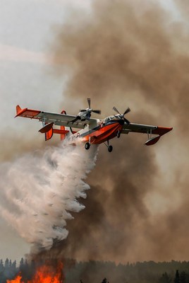 Firefighting Seaplane Dropping Water on Wildfire