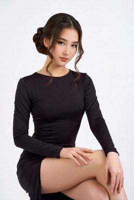 Asian woman in black dress sitting