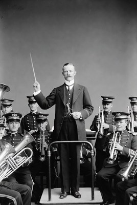 Conductor leading brass band
