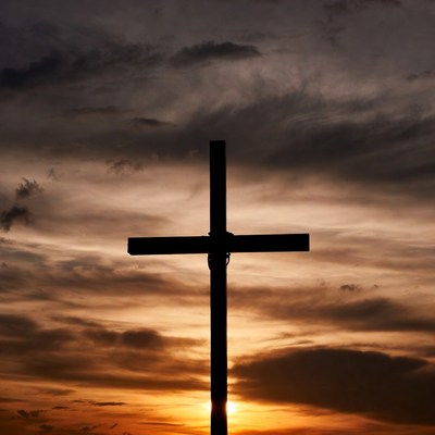 Silhouette cross at sunset