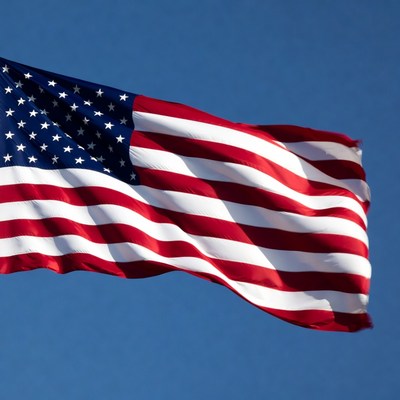 American Flag Waving Against Blue Sky