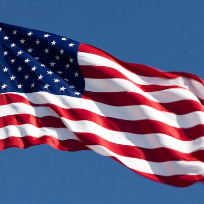 American flag waving against blue sky