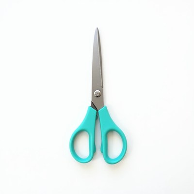 Turquoise scissors on white background