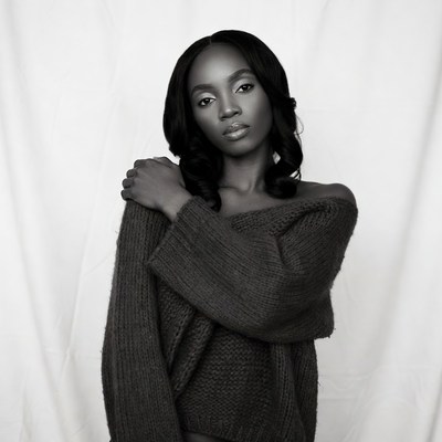 African-American woman in off-shoulder sweater