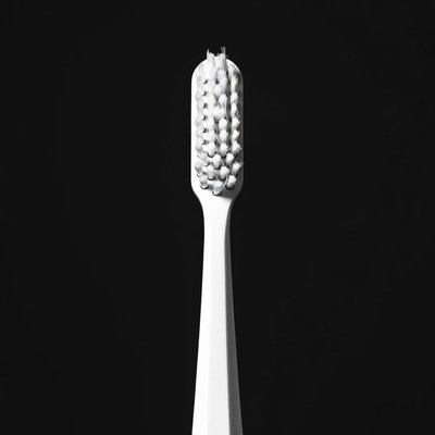 White Toothbrush on Black Background