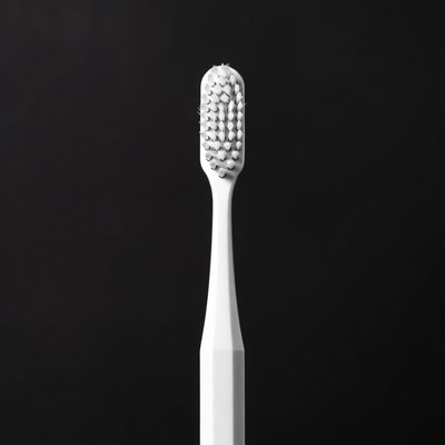 White toothbrush on black background