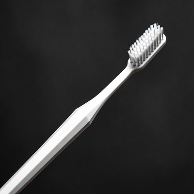 White Toothbrush on Black Background