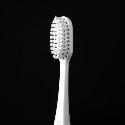 White Toothbrush on Black Background