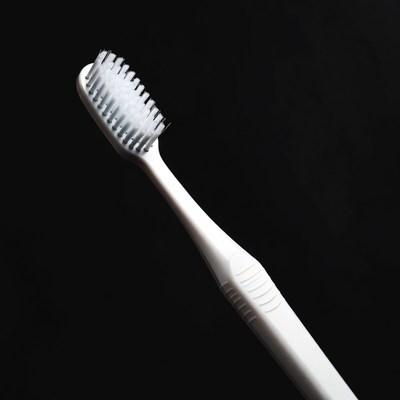 White Toothbrush on Black Background