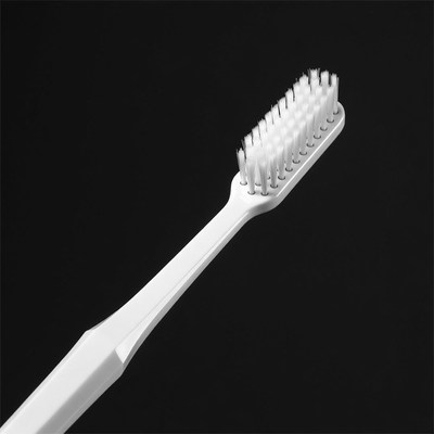 White toothbrush on black background