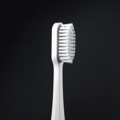 White Toothbrush on Black Background