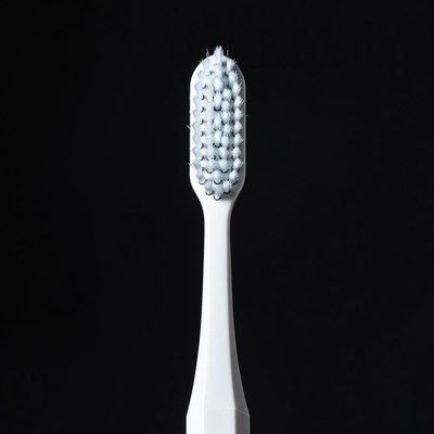 White toothbrush with blue bristles