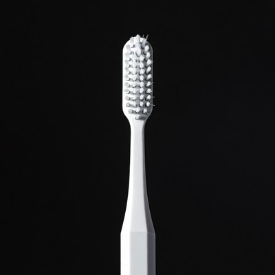 White Toothbrush on Black Background