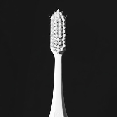White Toothbrush on Black Background