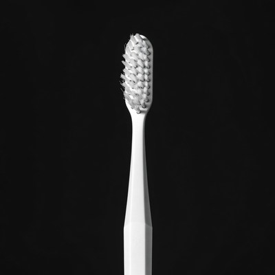 White Toothbrush on Black Background
