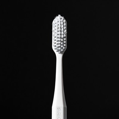 White Sonicare Toothbrush on Black Background