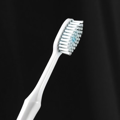 White Toothbrush on Black Background