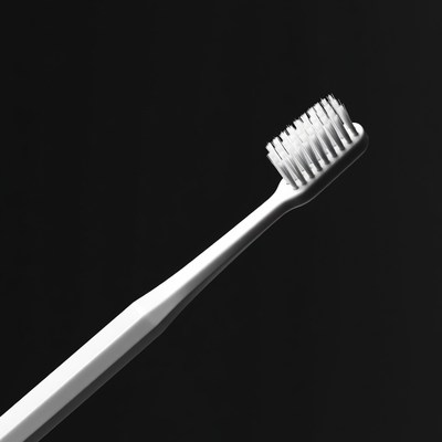 White Toothbrush on Black Background