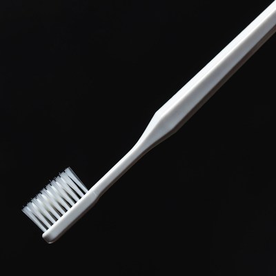 White toothbrush on black background