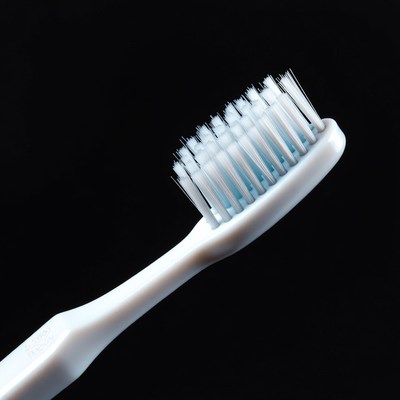 White toothbrush on black background