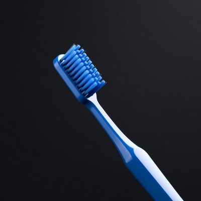 Blue toothbrush on black background