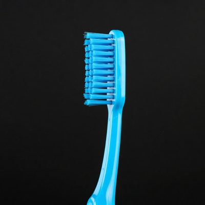 Blue toothbrush on black background
