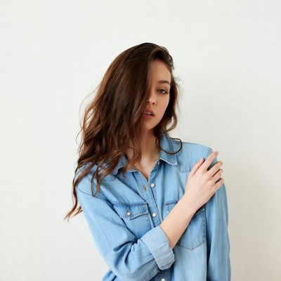Woman in denim shirt on white background