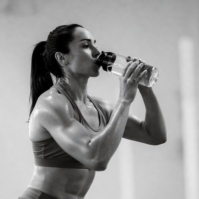 Fit woman drinking water bottle