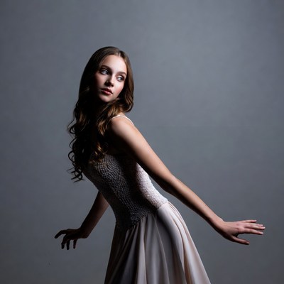 Young woman in flowing dress posing