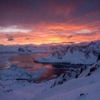 Antarctic Sunset Over Snowy Mountains