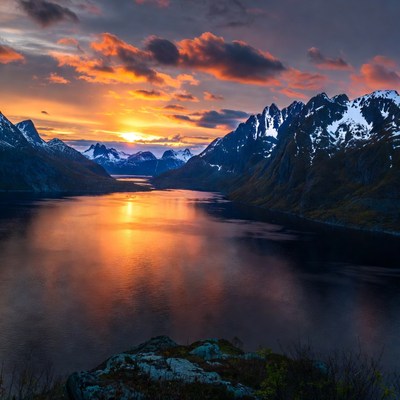 Sunset over snowy mountains and fjord