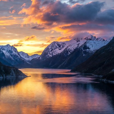 Sunset over Snowy Mountains and Fjord