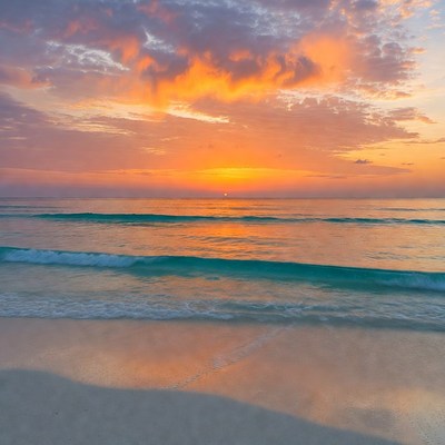 Sunset over turquoise ocean waves