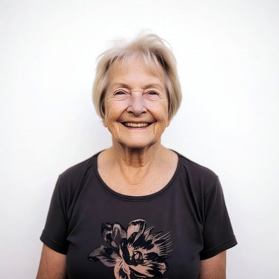 Elderly woman smiling with flower shirt