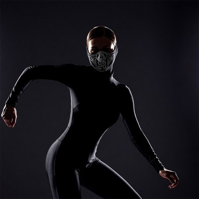 Woman in black bodysuit with tribal mask