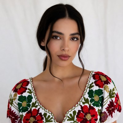 Woman in embroidered floral blouse