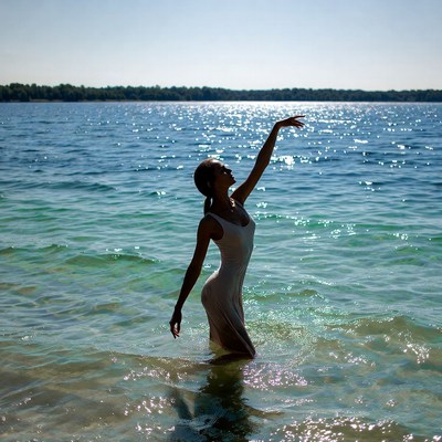 Woman dancing in lake water