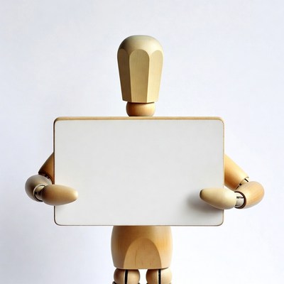 Wooden artist mannequin holding blank sign