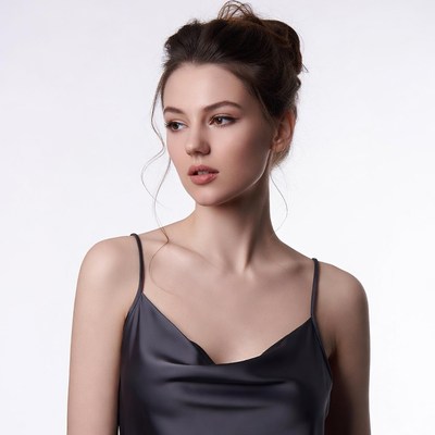 Woman in black silk slip dress