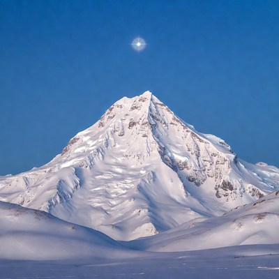 Snowy Mountain Peak with Sun