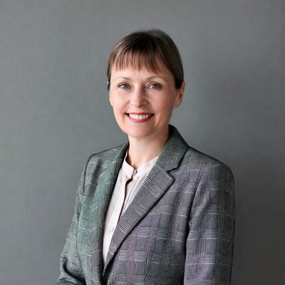 Smiling woman in plaid blazer