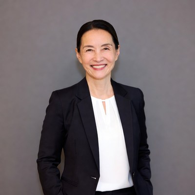 Asian woman in black suit smiling