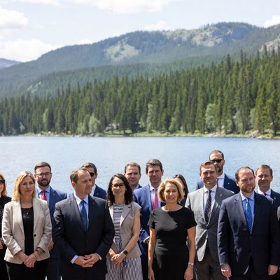 Group of business professionals by mountain lake